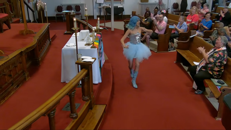 Drag Queen Collects Dollar Bills During Church Offertory, Stuffs Them Into His Bra